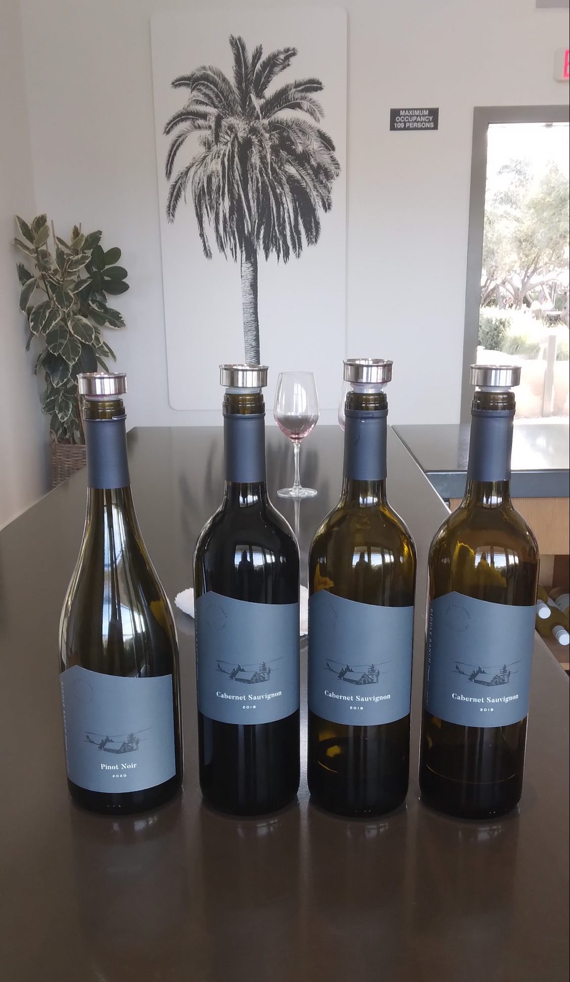 Biddle Ranch Vineyard wine bottles lined up on bar