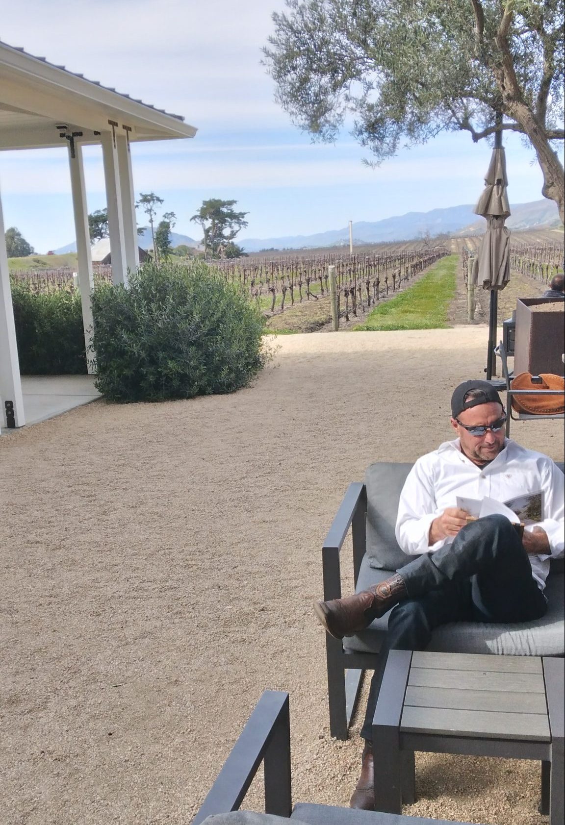 Biddle Vineyard Ranch - man sitting outdoors reading a menu